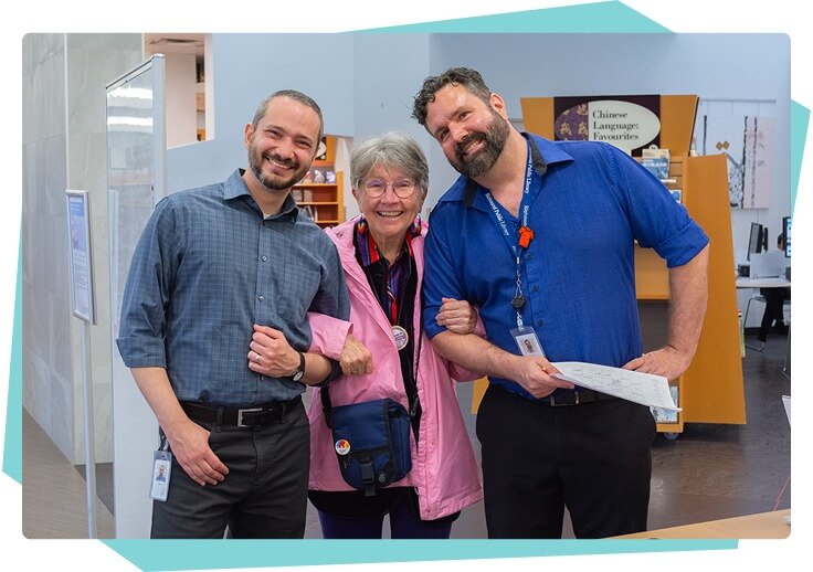 Group of adults linked arms in a library setting