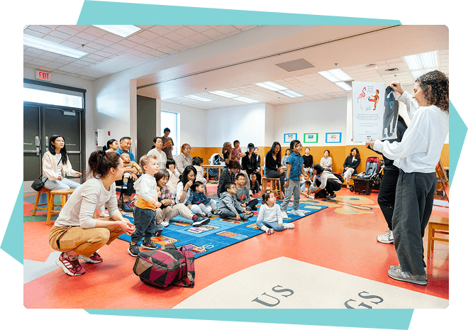 Families and children at a library story time reading event