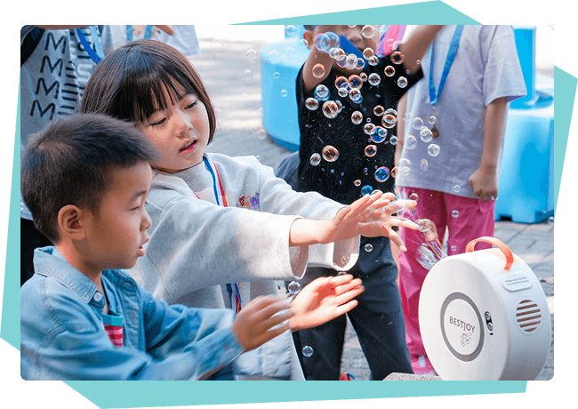 Children playing with a bubble machine